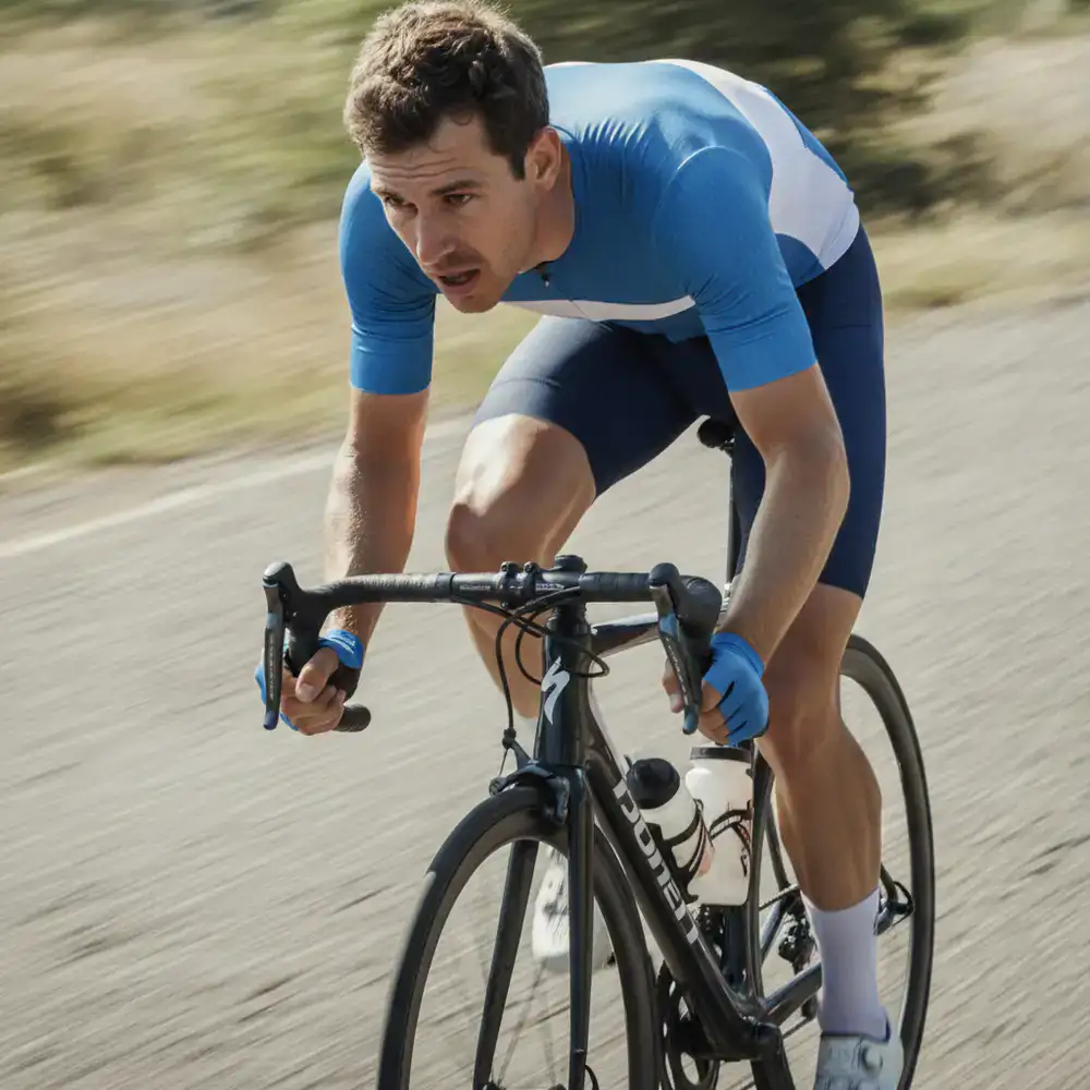 Close up crop of a cyclist sprinting on a road bike
